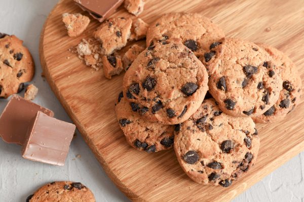 soft baked cookies with chocolate chips on top of wooden cutting board