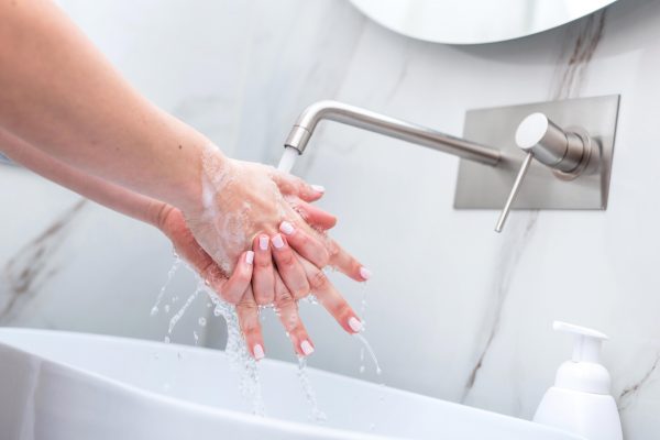 health-conscious person washing hands with proper method